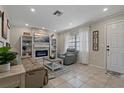 Cozy living room featuring a decorative fireplace, built-in shelves, and a comfortable seating area at 5036 Glenhurst Ln, New Port Richey, FL 34653