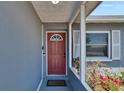 Close up of a front door, welcome mat, and flowering bushes at 5081 72Nd N Ave, Pinellas Park, FL 33781