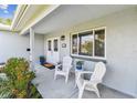 Cozy front porch features seating, a welcome mat, stylish double doors, and lush landscaping at 5235 42Nd S St, St Petersburg, FL 33711