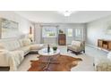 Bright living room features modern tile flooring, ample natural light, and stylish contemporary furnishings at 5235 42Nd S St, St Petersburg, FL 33711