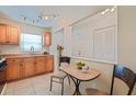 Cozy kitchenette features honey colored wood cabinets with track lighting at 5356 81St N St # 26, St Petersburg, FL 33709
