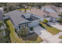 Well-maintained single-story home with a two-car garage, gray roof, and lush green lawn at 5538 Spanish Moss Cv, Bradenton, FL 34203