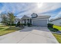 Charming single-story home with well-manicured lawn, blue accents and attached two car garage at 5538 Spanish Moss Cv, Bradenton, FL 34203