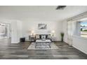 Bright living room with modern gray floors, stylish decor, and ample natural light at 5620 Perkin Dr, New Port Richey, FL 34652