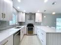 Updated kitchen featuring modern stainless steel appliances, sleek cabinetry, and recessed lighting at 6268 39Th N Ave, St Petersburg, FL 33709