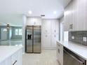 Spacious kitchen with stainless steel refrigerator, ample storage, and views into the adjacent living area at 6268 39Th N Ave, St Petersburg, FL 33709