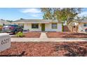 Inviting single-story home with green trimmed windows, a walkway, and freshly mulched landscape at 6325 9Th S Ave, Gulfport, FL 33707