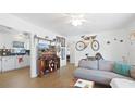 Cozy living room featuring stylish wood floors, a comfortable gray sofa, and unique wall decorations at 6325 9Th S Ave, Gulfport, FL 33707