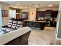 Spacious living room with an open floor plan that flows into a modern kitchen at 6325 Yellow Buckeye Dr, Riverview, FL 33578
