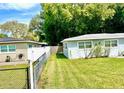 Spacious backyard featuring lush green grass and a fence, perfect for outdoor activities at 6507 N 21St St, Tampa, FL 33610
