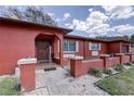 Eye-catching home featuring a vibrant exterior, landscaped garden, and covered entryway at 7117 Wrenwood Cir, Tampa, FL 33617
