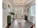 Inviting foyer with hardwood floors, white door, chandelier, and decor throughout at 7423 Sungold Meadow Ct, Apollo Beach, FL 33572