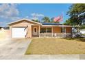 A well-maintained single-Gathering home with an attached garage and a charming front porch at 8039 83Rd N St, Seminole, FL 33777