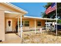 Inviting front porch featuring neutral colors, a decorative wreath, and patriotic decor at 8039 83Rd N St, Seminole, FL 33777