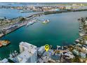 Waterfront home with dock, boat lift, and expansive views of the bay and marina at 94 Devon Dr, Clearwater Beach, FL 33767