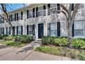 Close up view of an inviting townhome exterior showcasing manicured landscaping at 9506 Harpender Way, Tampa, FL 33626