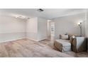 Bright living area with wood-look floors, neutral paint, and comfortable seating at 9812 N Pawnee Ave, Tampa, FL 33617