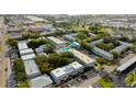 Aerial shot features complex with lush landscaping, pool, and ample parking in a neighborhood with surrounding businesses at 1115 Rue Des Chateaux # 2B, South Pasadena, FL 33707