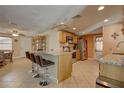 Open concept kitchen with granite countertops, stainless steel appliances, and breakfast bar at 11665 Leisure W Ln, Largo, FL 33773