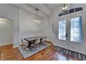 Bright dining room with hardwood floors, stylish lighting, and seating for six at 16516 Bridgewalk Dr, Lithia, FL 33547