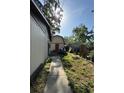 Exterior backyard view shows a home and detached garage with a red door at 1703 N Taylor Rd, Brandon, FL 33510