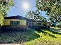 Inviting single-story home featuring lush lawn and shade trees in a serene setting at 1703 N Taylor Rd, Brandon, FL 33510