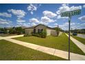 Corner lot featuring a single-story home with a lush lawn and beautifully landscaped yard at 19047 Alfaro Loop, Spring Hill, FL 34610