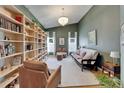 Inviting living room featuring a custom bookshelf, high ceilings, and natural light at 1910 Elk Spring Dr, Brandon, FL 33511
