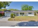 Charming single story home with a well maintained front lawn and beautiful landscaping at 1952 Algonquin Dr, Clearwater, FL 33755