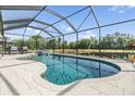 Sparkling screened-in pool with serene pond views and inviting poolside seating at 19837 Lonesome Pine Dr, Land O Lakes, FL 34638