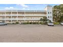 Lovely exterior of the condo building with unique tower feature and large parking lot at 2221 Swedish Dr # 55, Clearwater, FL 33763