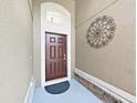 Covered front door entry featuring decorative metal art and contemporary design elements at 2405 Dakota Rock Dr, Ruskin, FL 33570