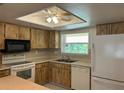 Bright kitchen with ample cabinet space, modern appliances including a refrigerator and dishwasher, and a sunny window at 2567 Oakleaf Ln # 41B, Clearwater, FL 33763