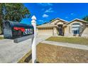 A beautifully landscaped front yard with mailbox, walkway to covered entryway and two car garage at 2604 Clareside Dr, Valrico, FL 33596
