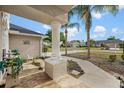 Column supporting front porch, tiled floor, a decorative fountain, and landscaping at 3434 St Ives Blvd, Spring Hill, FL 34609