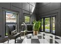 Elegant foyer with black and white checkered floors, statement walls, and a view to the front yard at 3501 W Tacon St, Tampa, FL 33629