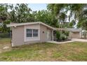 Charming one-story home with neutral stucco, white trim, and complemented by landscaped front yard at 3601 Grayton Dr, New Port Richey, FL 34652