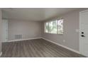 Bright living room featuring new gray wood-look flooring and lots of natural light at 3601 Grayton Dr, New Port Richey, FL 34652