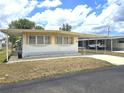 This single-story house has covered parking, mature landscaping, and a well-maintained yard at 37135 Sandra Ave, Zephyrhills, FL 33542