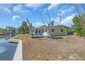 Backyard view with wooden deck and waterside seating, offering a serene outdoor living space at 396 Avenida Madera, Sarasota, FL 34242