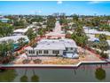 Charming waterfront home featuring a private dock, outdoor deck, and tropical landscaping at 396 Avenida Madera, Sarasota, FL 34242