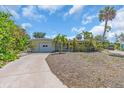 Charming home featuring an attached garage, mature landscaping, and a spacious driveway at 396 Avenida Madera, Sarasota, FL 34242
