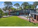 Beautiful modern home boasting mature trees and manicured landscaping, highlighting its stylish design and inviting facade at 4610 Cypress S Way, St Petersburg, FL 33705