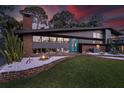 Beautiful mid-century modern home with brick and gray exterior, plus manicured lawn and garden at 4610 Cypress S Way, St Petersburg, FL 33705