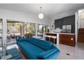 Open concept living room with modern furniture, a bar seating area, and sliding doors leading to an outdoor patio at 4610 Cypress S Way, St Petersburg, FL 33705