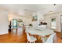 Cozy dining area with a marble table and white chairs, showcasing an open-concept layout and natural light at 4681 Carson Ne St, St Petersburg, FL 33703