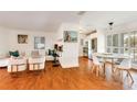 Inviting living space with wood floors, a white couch and chairs, and a stylish marble table in dining area at 4681 Carson Ne St, St Petersburg, FL 33703