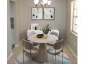Staged dining area with a round table, modern chairs, and contemporary artwork at 4725 Joseph Ct # 233, Tampa, FL 33614