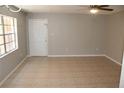 Unfurnished living room showcasing tile flooring, neutral paint, bright windows and ceiling fan at 4725 Joseph Ct # 233, Tampa, FL 33614