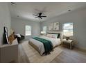 Stylishly decorated bedroom with a large bed, windows, neutral color palette, and a ceiling fan at 4920 72Nd N St, St Petersburg, FL 33709